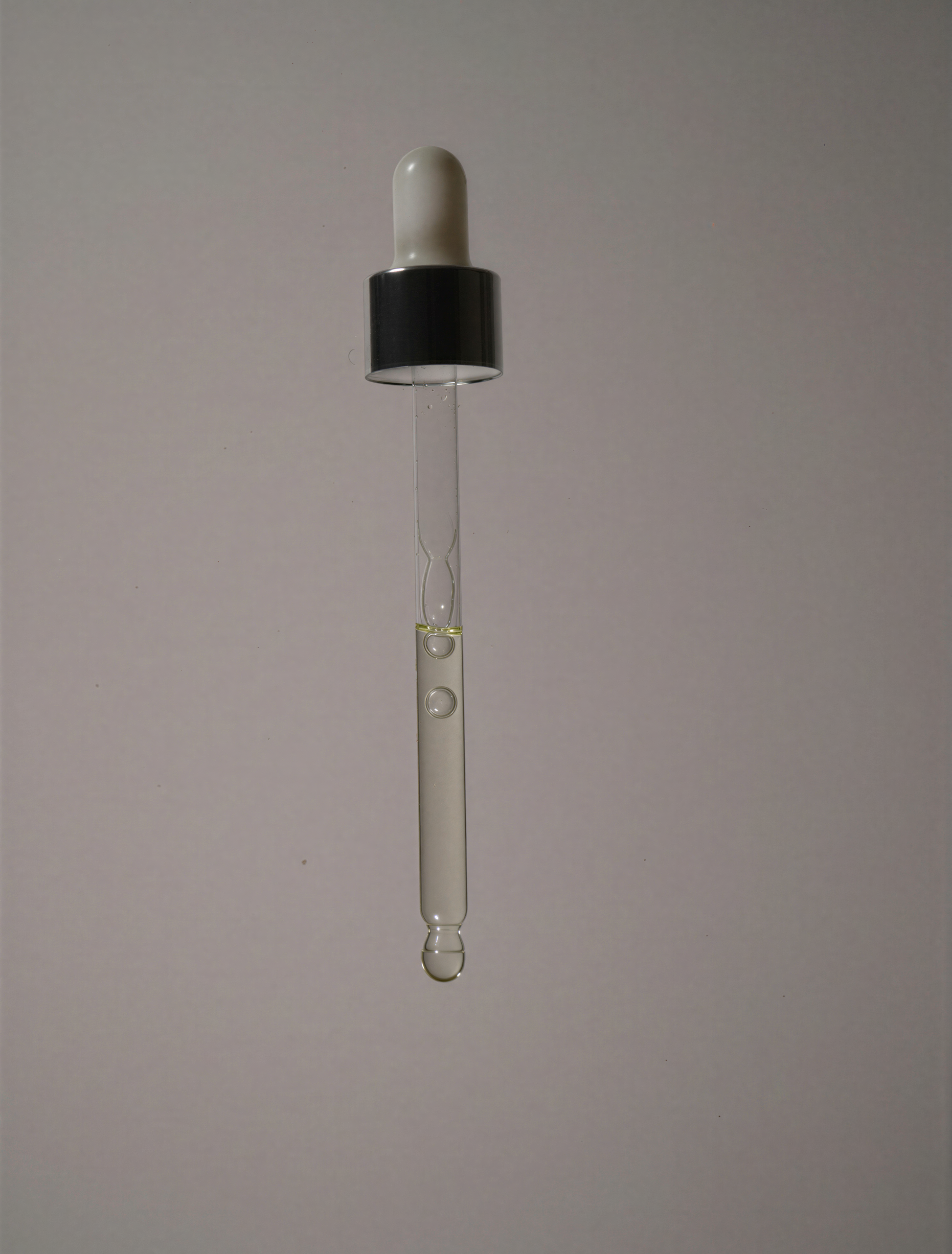 Oil dropper mid air, texture golden liquid