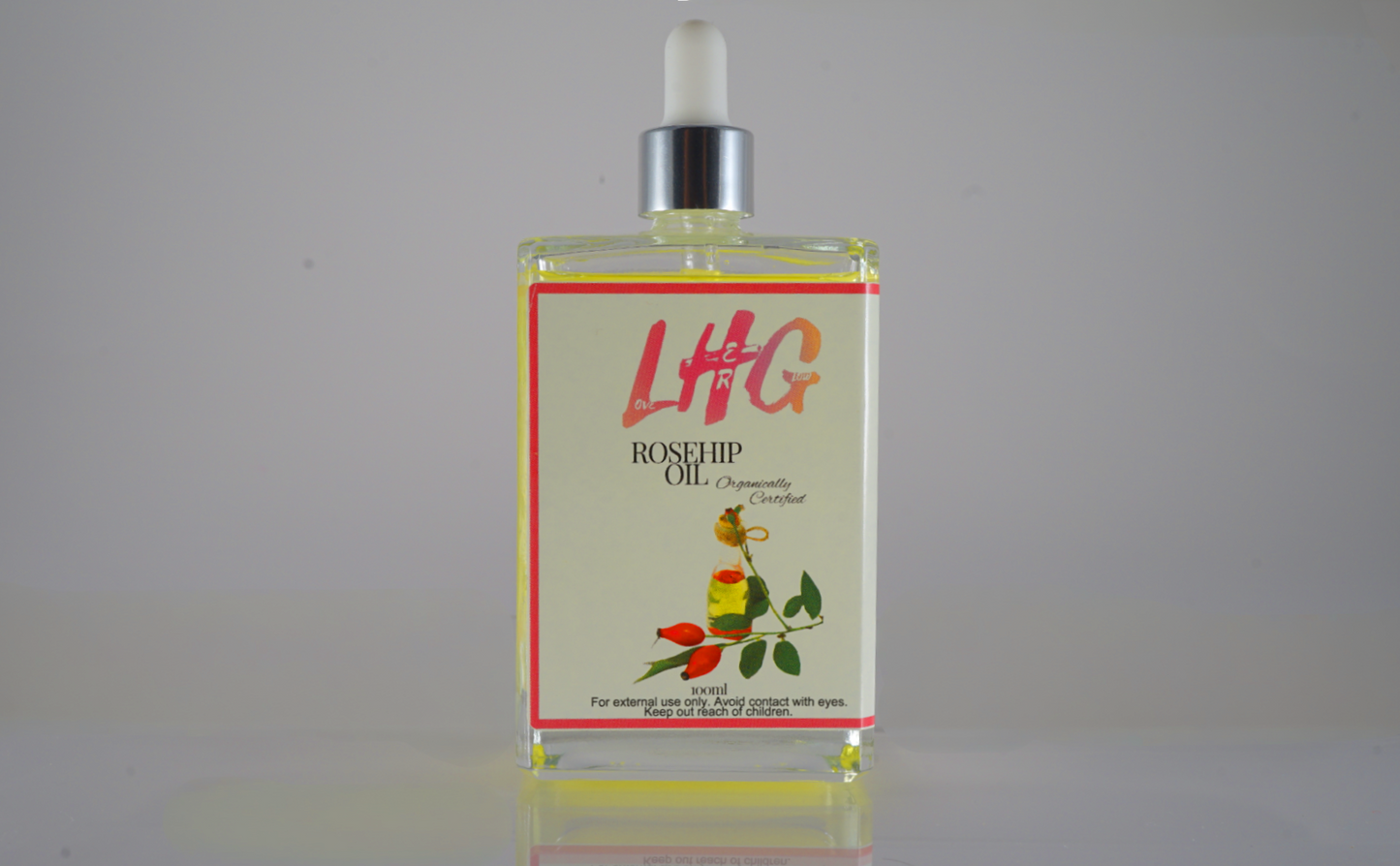LHG rosehip oil bottle with dropper on a gray background